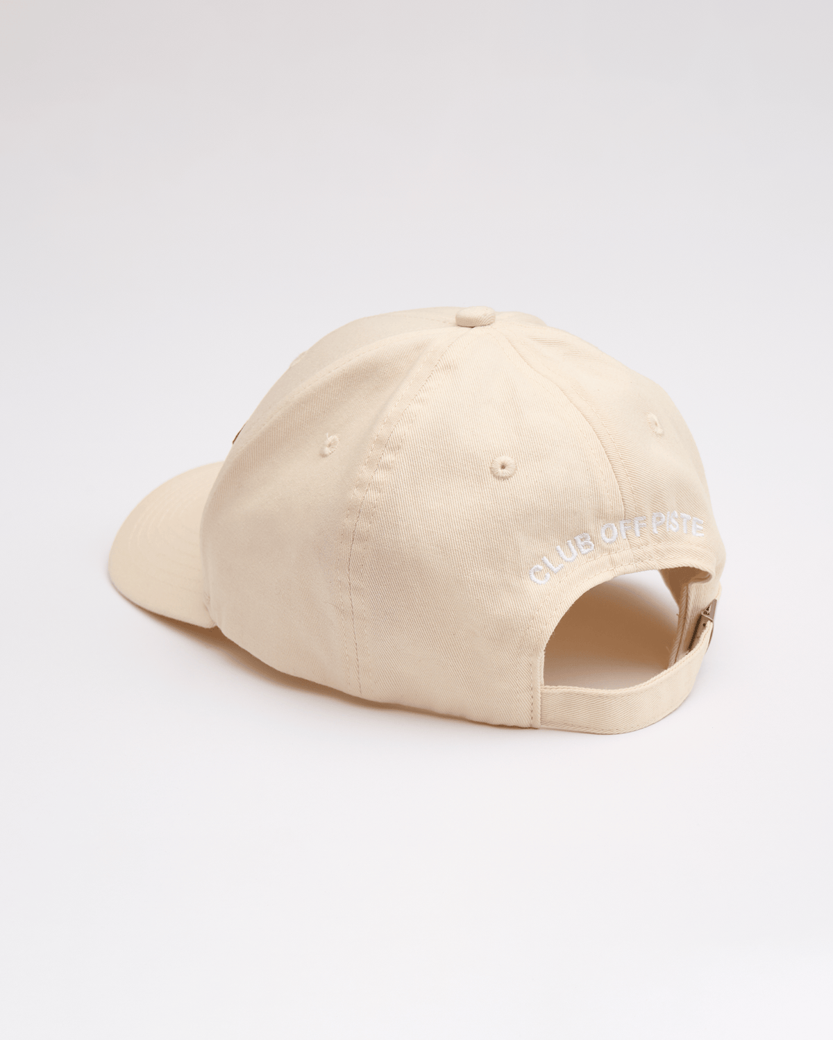 Beige cap with "Club Off Piste" written on it