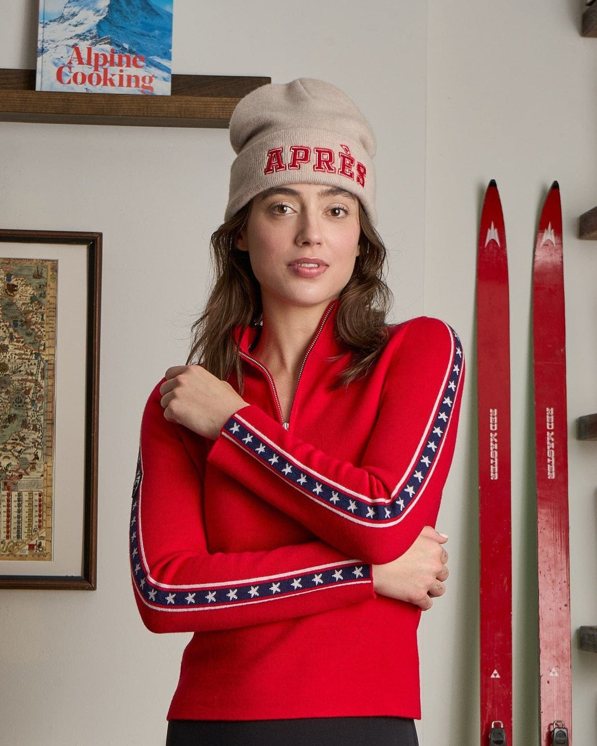 woman wearing red ski sweater with stars and stripes on the sleeves in merino wool